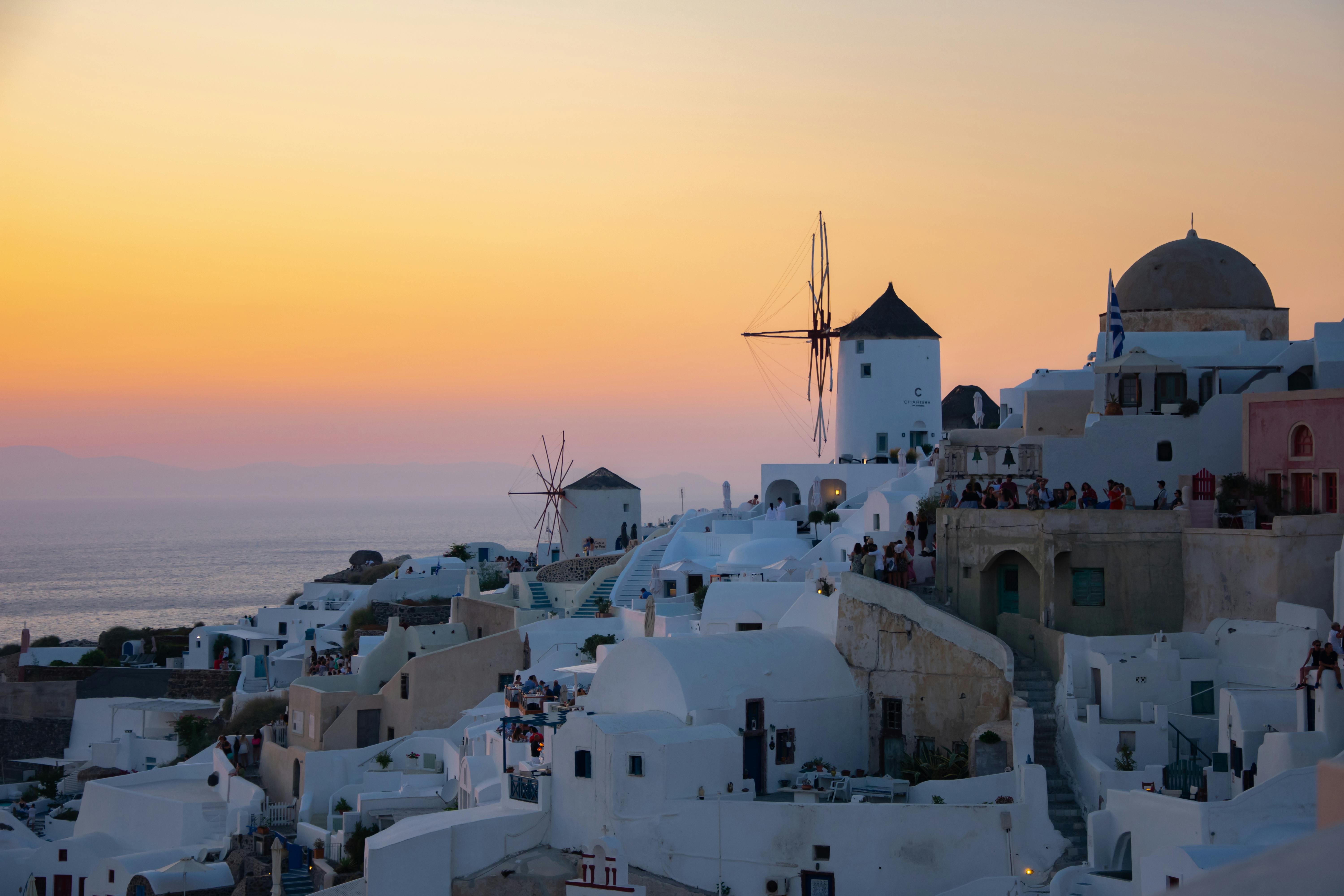 Santorini at Dusk: A Palette of Warm Orange and Gentle Pink Painting the Sky and Sea
